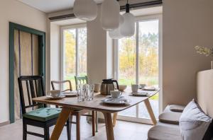 LüderFerienwohnungen in Wald und Flur - Wohnung Wald的一间带木桌和椅子的用餐室