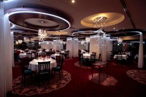 代姆延卡斯凯德度假酒店及spa中心的用餐室配有桌椅和吊灯。