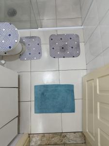 圣保罗Casa da Vila Hostel Guest House的浴室铺有白色瓷砖和蓝色地毯。