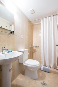 米里纳Afrodite Hotel Apartments的浴室配有白色卫生间和盥洗盆。