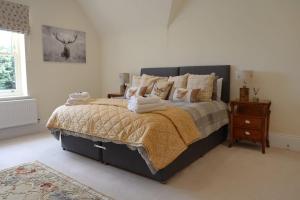 WeetonBridge House Farm的一间卧室配有一张大床和一个床头柜