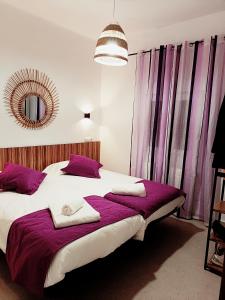 马德里Violeta Suite的一间卧室配有一张大床和紫色窗帘