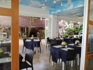 长滩岛Signature Boracay South Beach的餐厅设有桌椅和蓝色的桌子