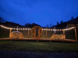 GhimeşBiotour Camping & Restaurant的一间晚上有灯的木屋