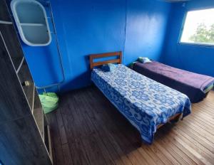 维纳德马Casa yeici的一间设有两张床和蓝色墙壁的客房