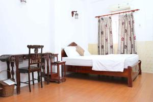 河内HOÀNG CƯỜNG HOTEL 15 Nguyễn Thái Học的一间卧室设有两张床、一张桌子和一个窗口