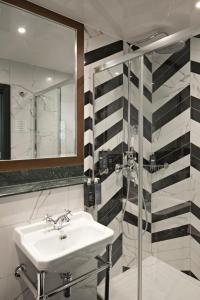 伦敦The Portico Hotel的一间带水槽和镜子的浴室