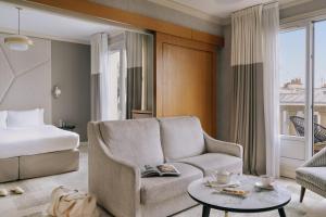 巴黎Atala powered by Sonder的客厅配有床、沙发和椅子