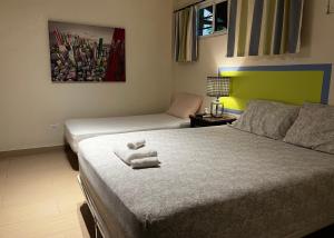 Paraiso Natural Casita 2的一间卧室配有两张床,床上配有毛巾