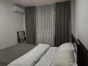 第比利斯View Corner的一间卧室配有床和带窗帘的窗户