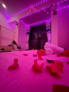 大叻House Thị Đà Lạt的紫色客房,配有一张粉红色照明床