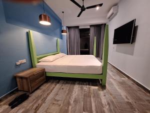 米瑞莎Marino Mirissa的一间卧室设有一张绿色的床和一台电视。