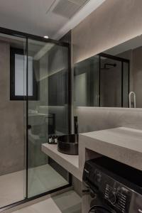 约阿尼纳No Stars - Luxury Hotel Apartments的一间带水槽和玻璃淋浴的浴室