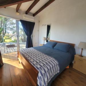 La AguadaCasa Encantada Guest House的一间卧室设有一张床和一个大窗户