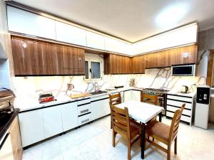 西迪基里尔Resort altayar Villa altayar 2- Aqua Park的厨房配有木制橱柜和桌椅