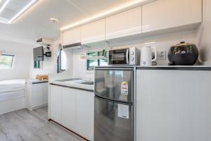 加平Gapyeong Olden Caravan & Pension - Pet Friendly的厨房配有白色橱柜和冰箱。