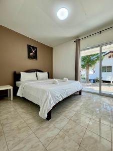 尖竹汶Fundee Resort的一间卧室设有一张大床和一个大窗户