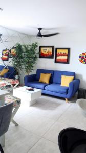 比亚维森西奥VILLAVICENCIO! Increíble, Hermoso y moderno APARTAMENTO COMPLETO, con PISCINA!的客厅配有蓝色的沙发和黄色的枕头。