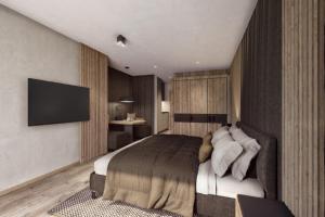索尔登索登格伦瓦尔德度假酒店的一间卧室配有一张床和一台平面电视