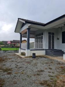 Pasir MasTeratak Che Esah Guest House FREE WIFI的一座带庭院的白色小房子