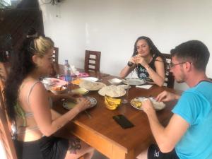 波隆纳鲁沃Senanayaka Holiday Inn的一群坐在桌子旁吃食物的人