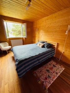 巴斯洛内特Chalet Barcelonnette - location saisonnière的木制客房内的一间卧室,配有一张床