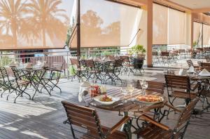 库萨达斯Aqua Fantasy Aquapark Hotel & Spa - Ultra All Inclusive的一间餐厅配有桌椅,提供食物