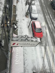 普奇塞达终点站酒店的两辆汽车停在雪地上的街道上