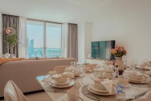 迪拜Capital Stay - 2 Bed Apartment in Dubai Festival City的客厅配有桌子和沙发