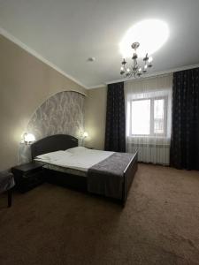 塞米伊VIP Mini Hotel的一间卧室配有一张大床和一个吊灯。