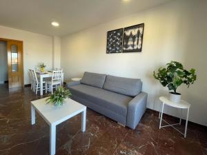 萨拉戈萨Apartamentos El Pilar Suites 3000的客厅配有沙发和桌子