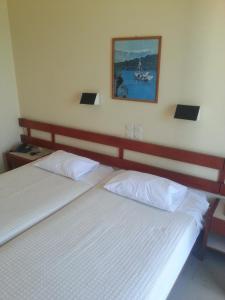 爱琴娜岛Hotel Avra的卧室内的两张床,墙上挂着一幅画