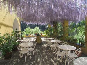 莱万托Villanova - Nature & Wellness的一个带桌子和椅子的紫色花卉天井