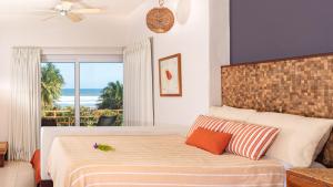 ChirilaguaLas Flores Resort的一间卧室设有一张床,享有海景