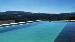 阿利若Country house Quinta da Salgueira的一座大游泳池,后面是群山