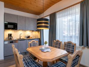 菲根德尼斯公寓酒店的厨房以及带木桌和椅子的用餐室。
