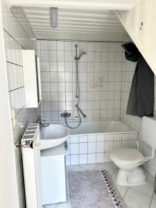 莱茵河畔威尔Bequemes und helles Einfamilienhaus mit Garten的带浴缸、卫生间和盥洗盆的浴室