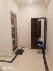 根尼亚古马里Shanmuga Residency的一间设有蓝色椅子和镜子的客房