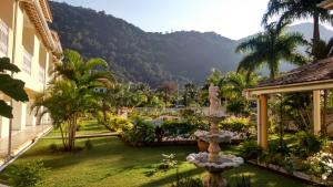 巴雷克萨巴Hotel Portal de Barequeçaba的一座花园,在一座建筑前方有一个喷泉