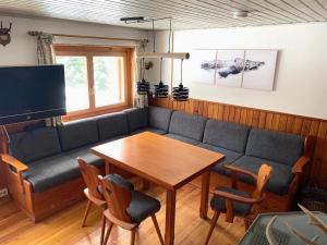 索内纳尔佩·纳斯费尔德Beautiful chalet apartment - ski-in & ski-out的带沙发和木桌的客厅
