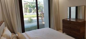 塞拉莱Maxim Hawana Salalah的一间卧室设有一张床和一个大型玻璃窗