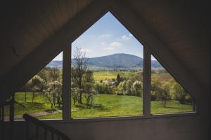 耶维克Beskid Sielski - klimatyczne domki w Lipowej z widokiem na góry i sauną - Dream Apart的窗外的绿色田野