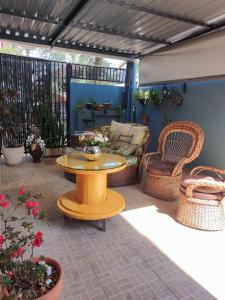 伊瓜苏科德斯道瓜旅馆的庭院配有桌子和藤椅