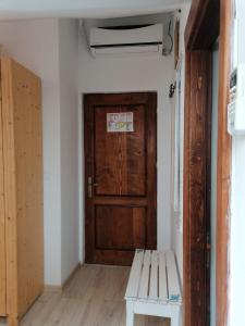 阿尔杰什河畔库尔泰亚Pensiunea Geostar的木门和长凳的房间