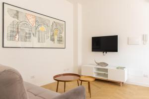 罗马Eur Laghetto casa vista lago Fattori的客厅配有沙发和墙上的电视