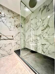 伦敦圣乔治码头水滨公寓的带淋浴和大理石墙壁的浴室