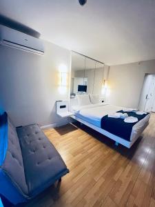 巴统Elite Class Sea View ApartHotel in Orbi city的一间卧室配有一张床、一把椅子和镜子