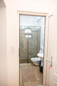 斯特鲁加Hotel Lux的一间带卫生间和玻璃淋浴间的浴室