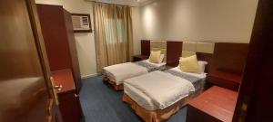 泰布克نجمة العنان للشقق المخدومة的一间酒店客房内设有两张床的房间