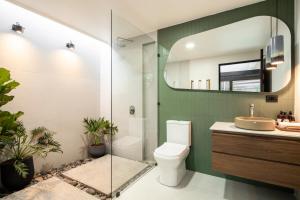 福尔图纳BAUMA的一间带卫生间、水槽和镜子的浴室